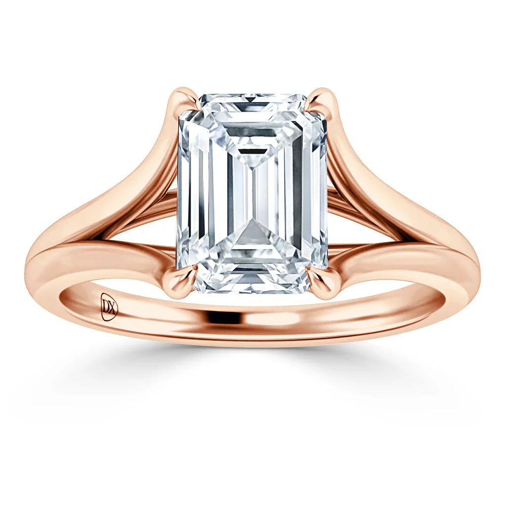 Emerald-cut diamond ring with a split rose gold band, shown on a white background.