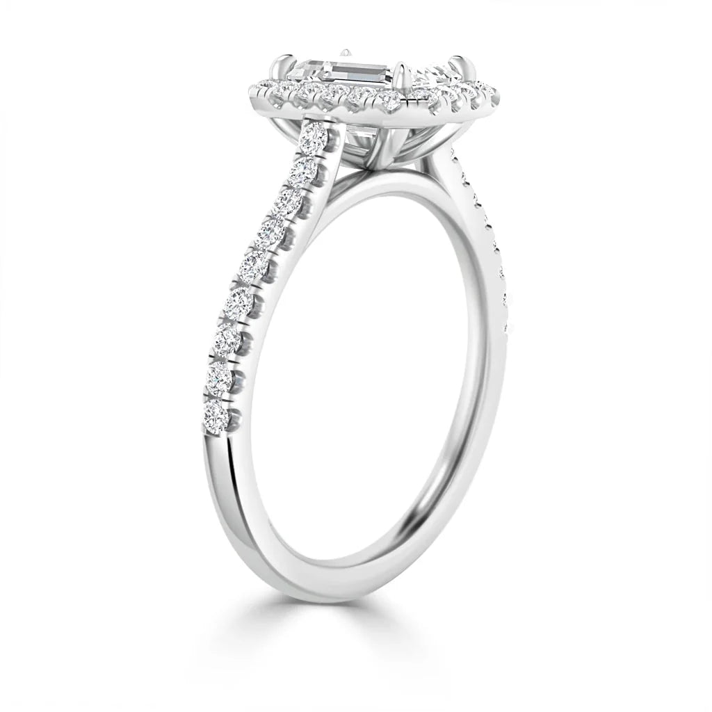 A white gold ring with a rectangular center diamond and small diamonds on the band and halo setting.