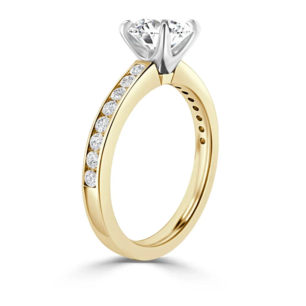 A gold ring with a row of small diamonds on the band and a large solitaire diamond in a prong setting.