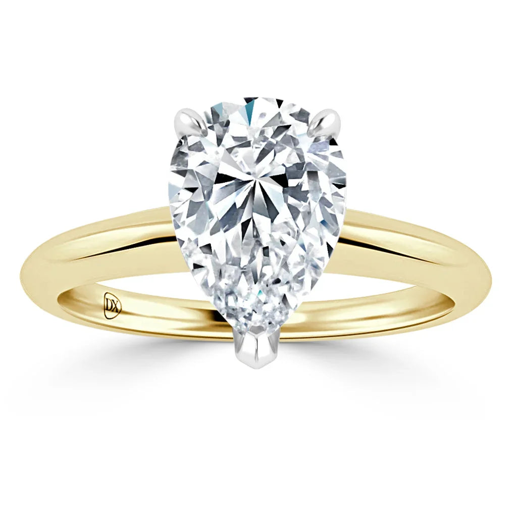 A gold ring with a large pear-shaped diamond solitaire set in a simple, polished band.