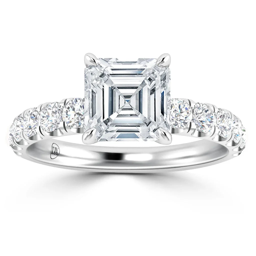 Platinum ring with a square-cut center diamond and round diamonds along the band, shown on a white background.