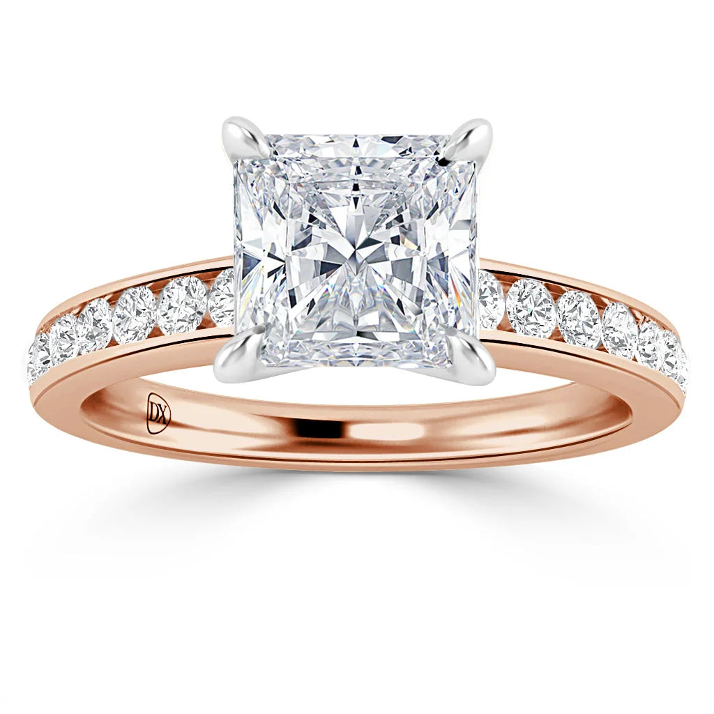 A rose gold ring with a large princess-cut diamond and smaller diamonds on the band.