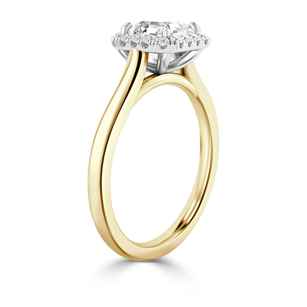 Gold band ring with a large round center diamond and smaller diamonds in a halo setting, side view.
