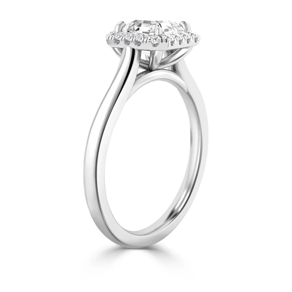 A white gold ring with a round diamond center stone and a halo of smaller diamonds, shown in a side view.