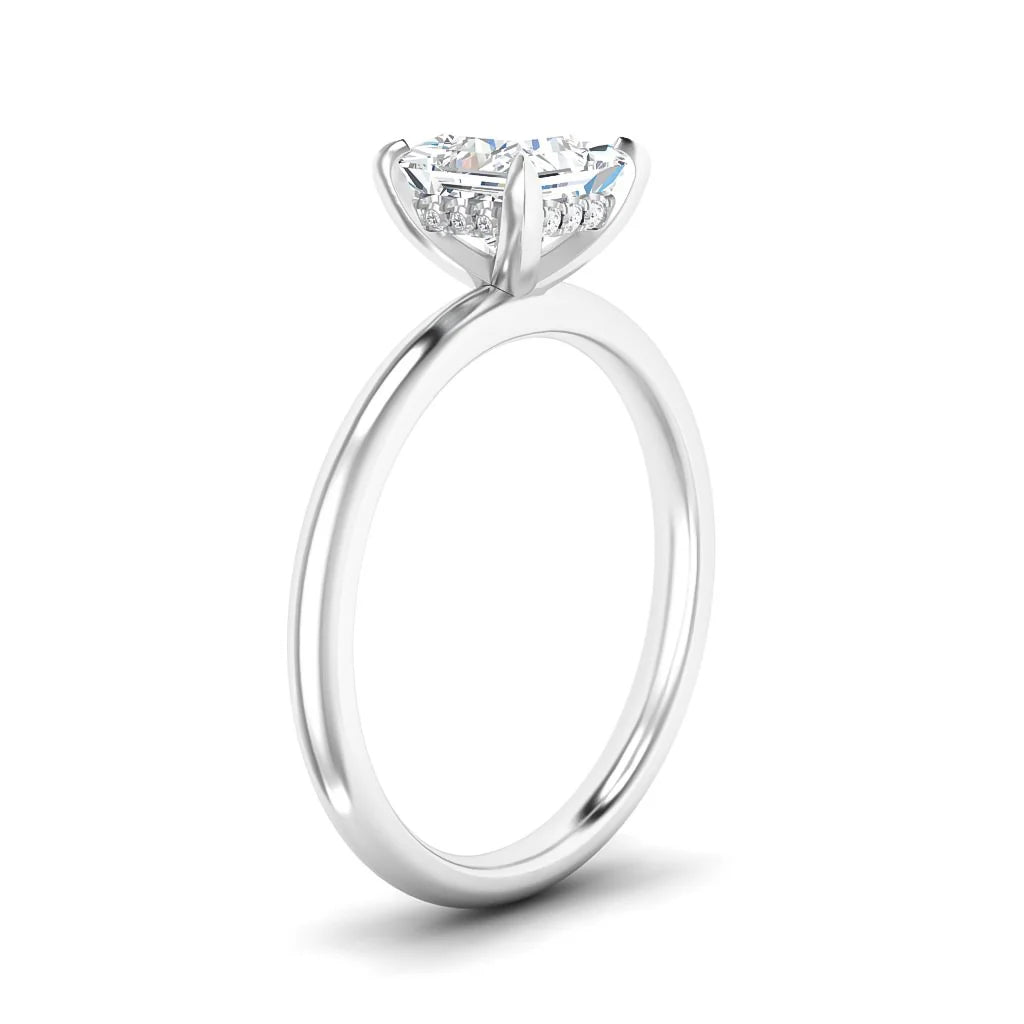 A solitaire diamond ring with a slim white gold band and prong setting shown from a side view.