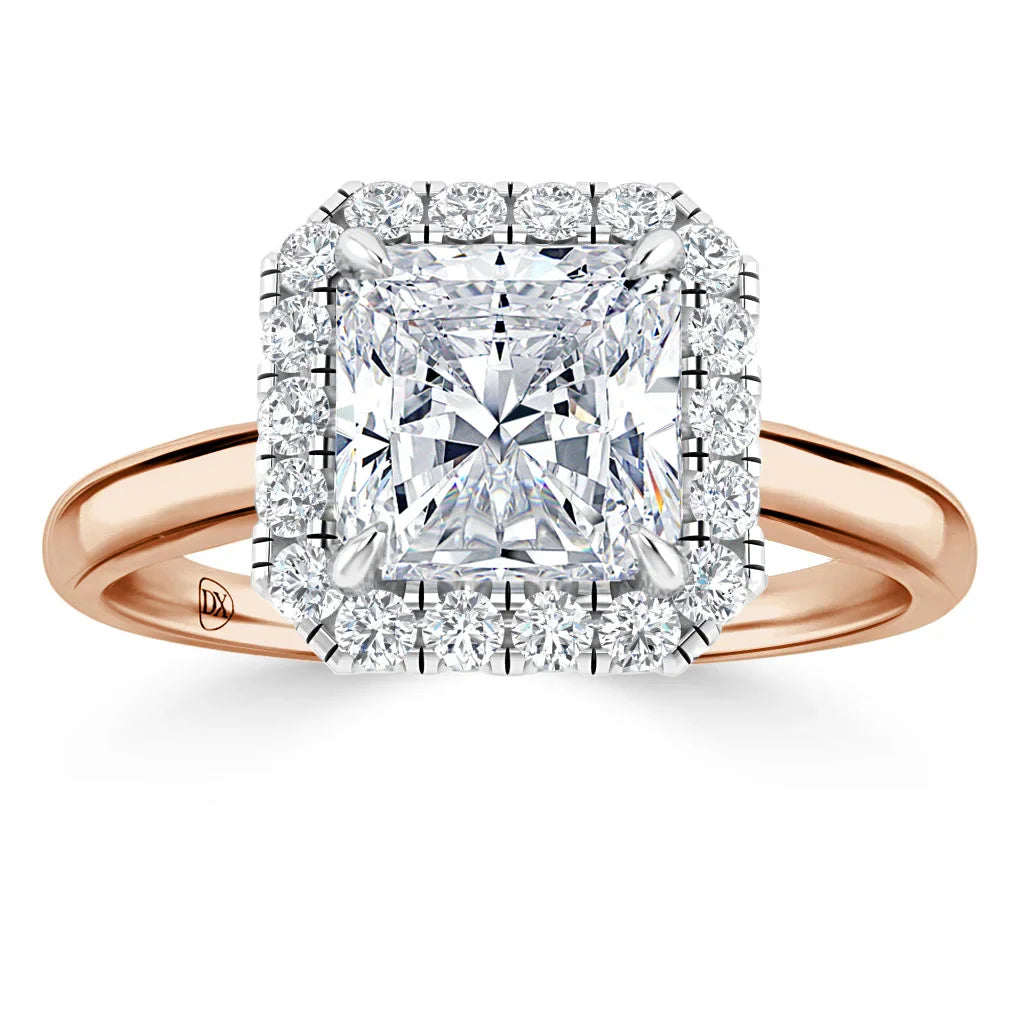 Rose gold ring with a large square-cut diamond, surrounded by a halo of smaller round diamonds.