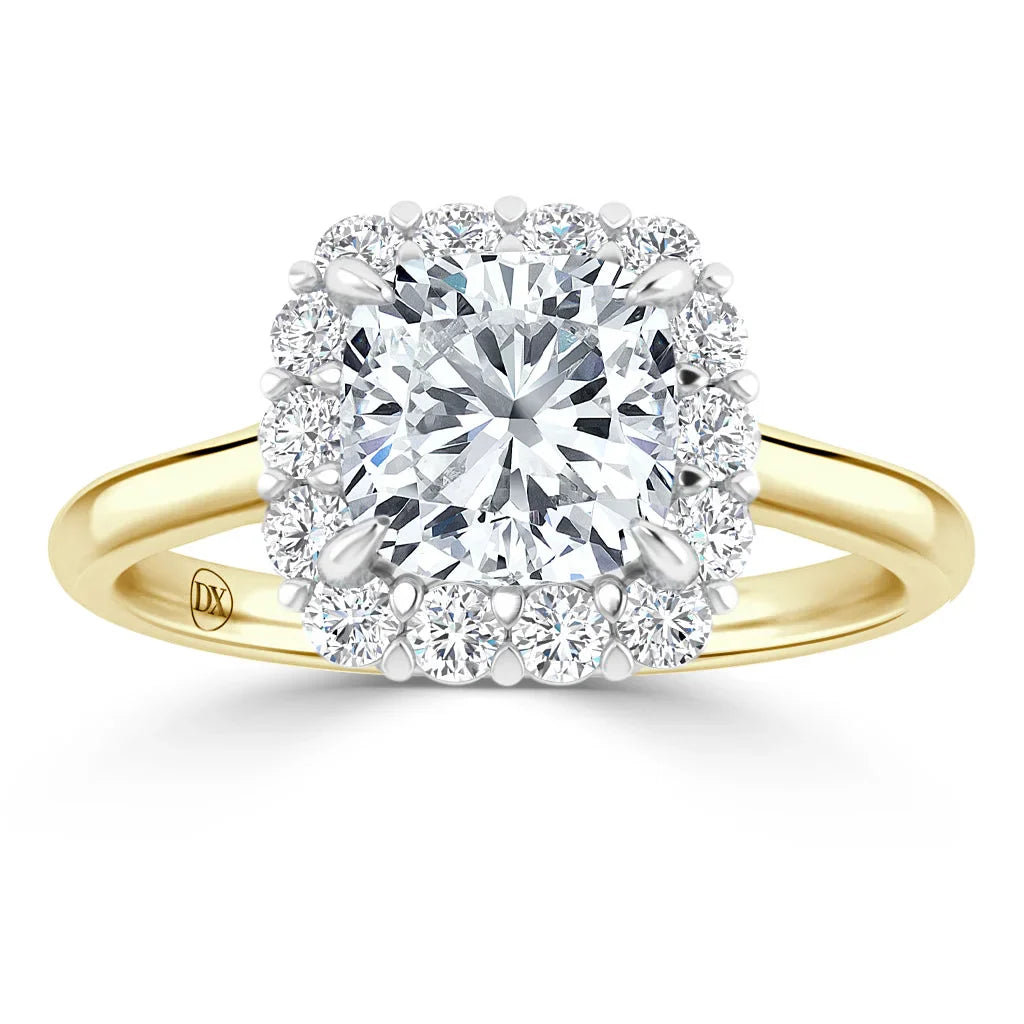 Gold ring with a central round diamond, surrounded by a cushion-shaped halo of smaller diamonds.