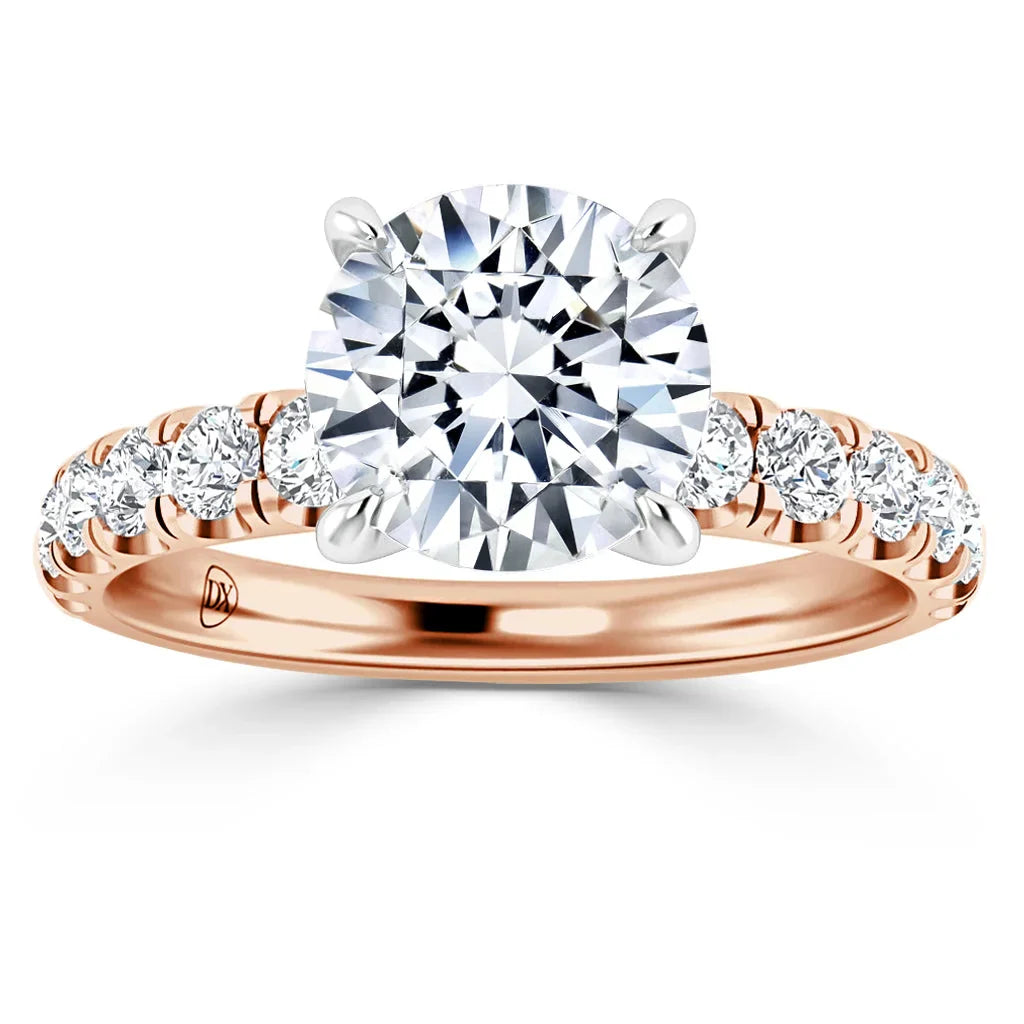 Rose gold ring with a large round diamond center stone and smaller diamonds set along the band.