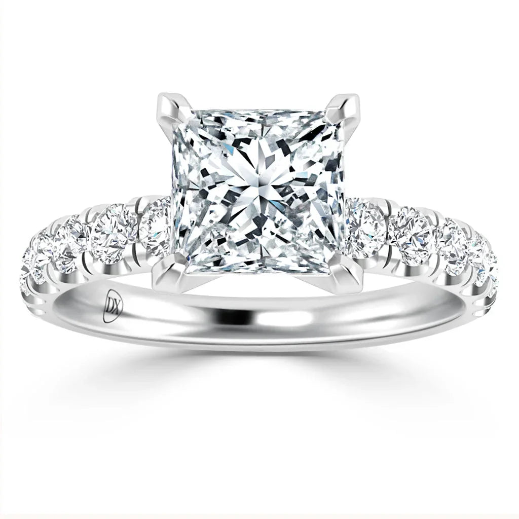 Platinum ring with a large princess-cut diamond center and smaller round diamonds on the band.