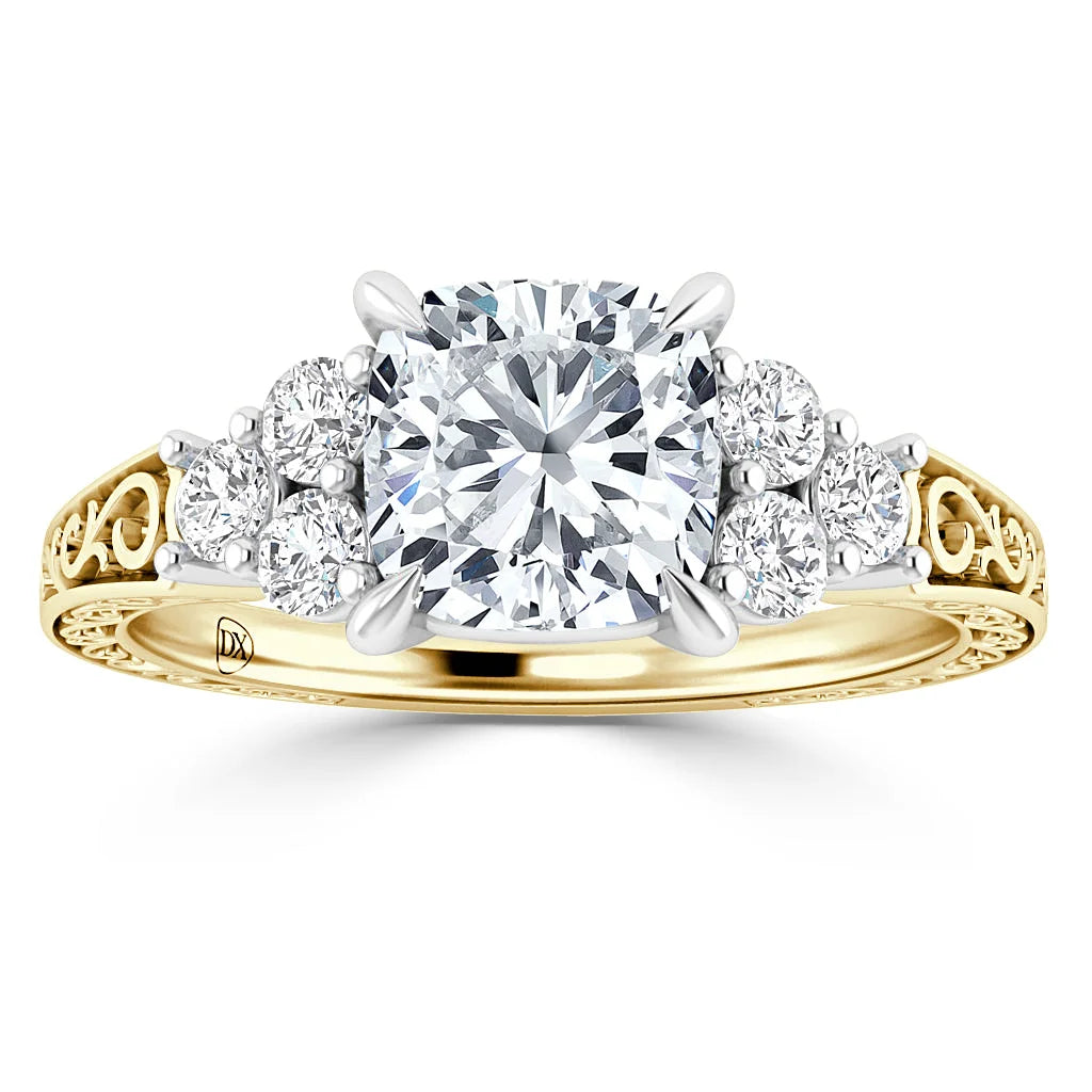 A gold ring with a large central diamond, six smaller side diamonds, and an ornate filigree band design.
