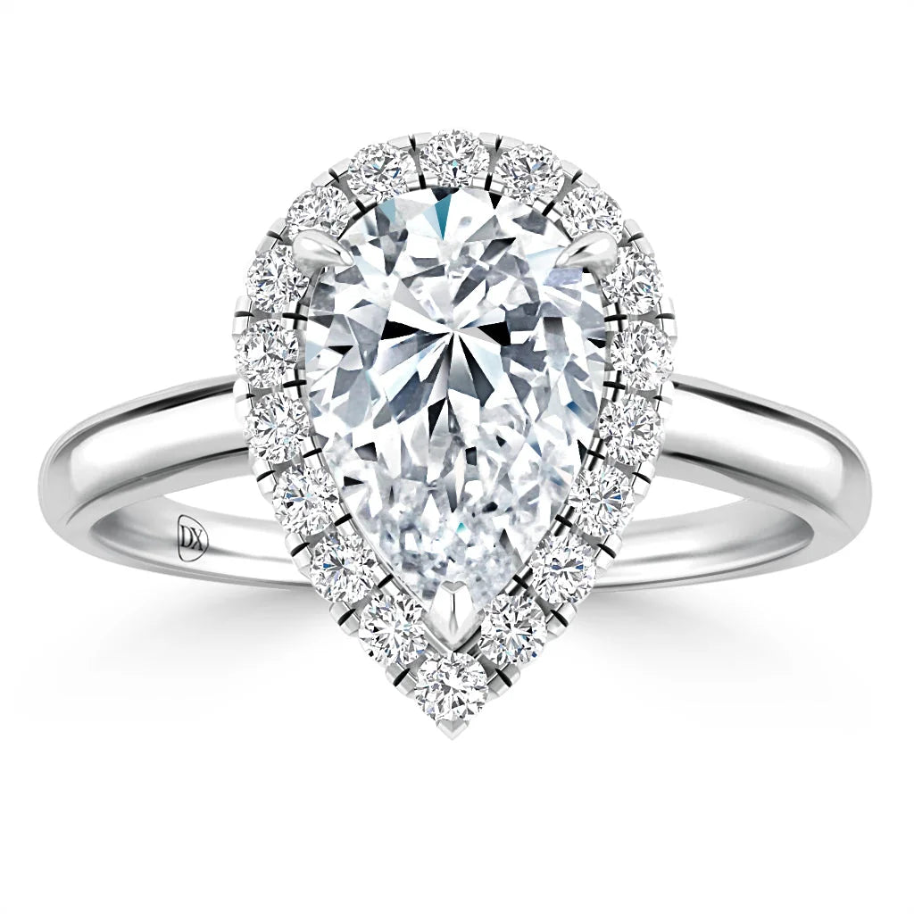 Pear-shaped diamond ring with a halo of small diamonds on a shiny white gold band, viewed from the front.
