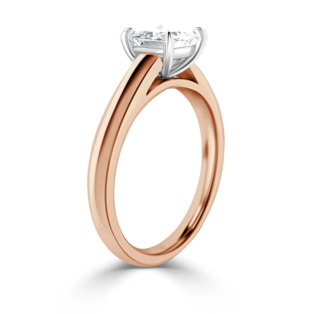 Rose gold solitaire ring with a round diamond in a white gold prong setting, shown on a white background.