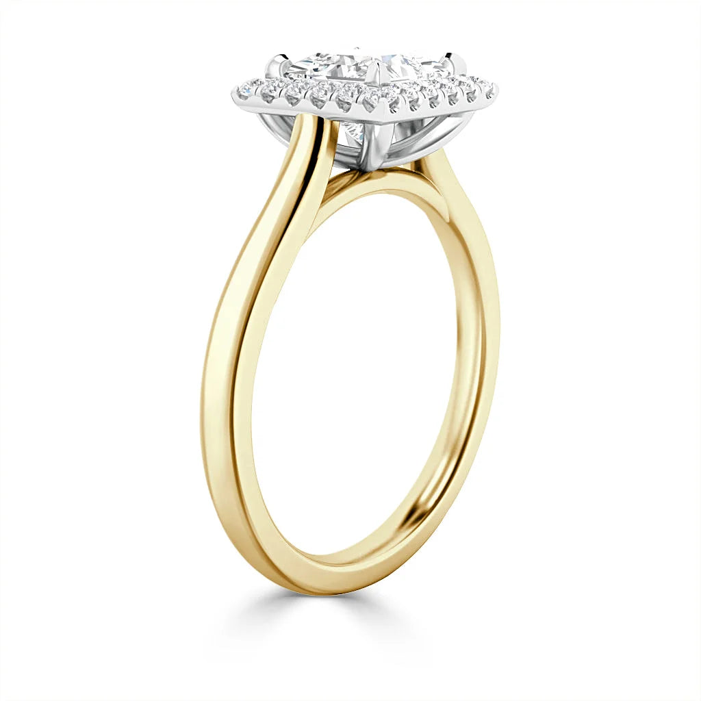 Gold band engagement ring with a round diamond center and a halo of smaller diamonds, viewed from the side.