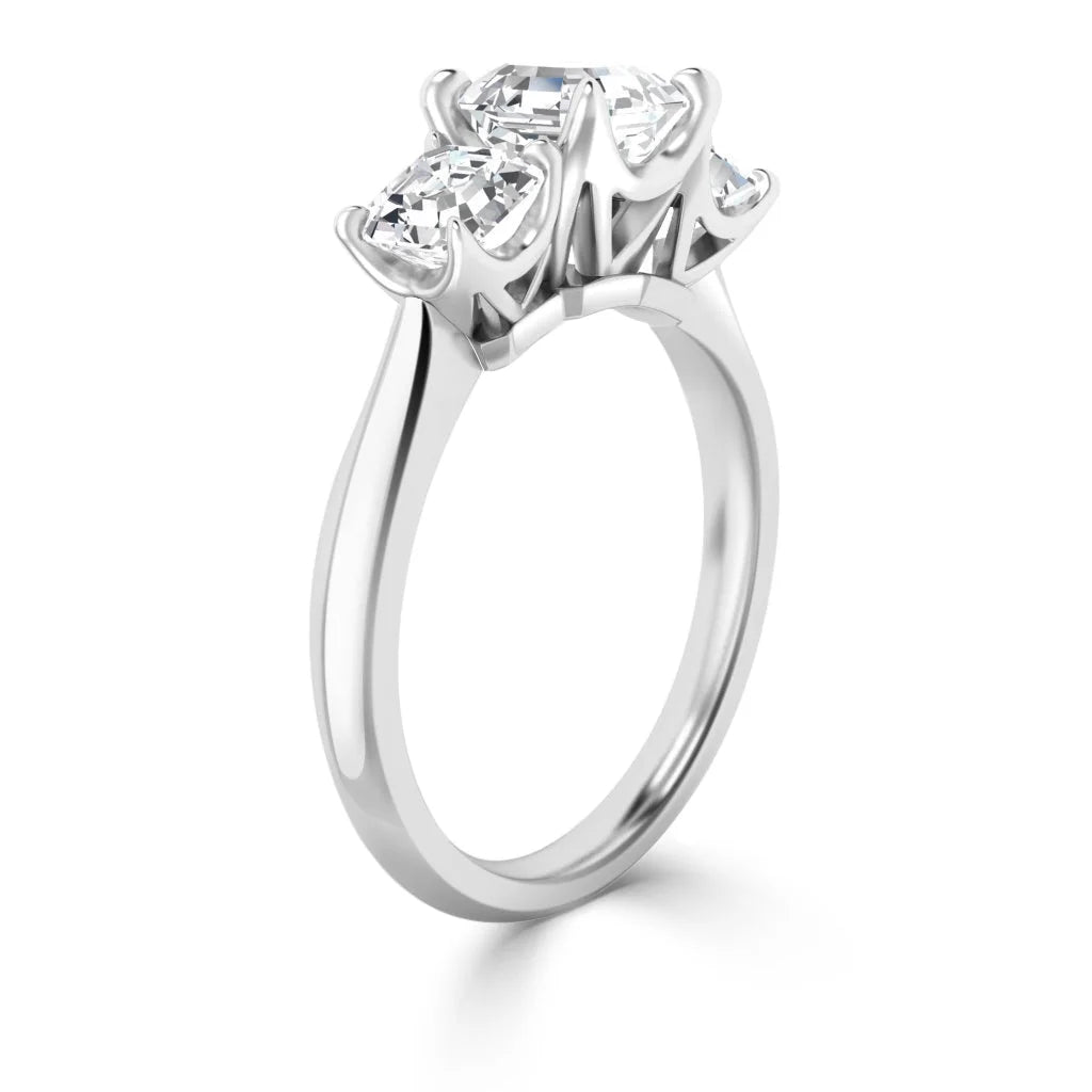 A white gold ring with three large, prong-set diamonds in a row on a plain, polished band.