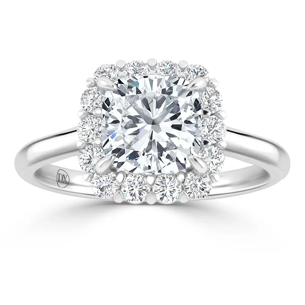 A silver ring with a round center diamond, surrounded by a halo of smaller diamonds on a plain band.