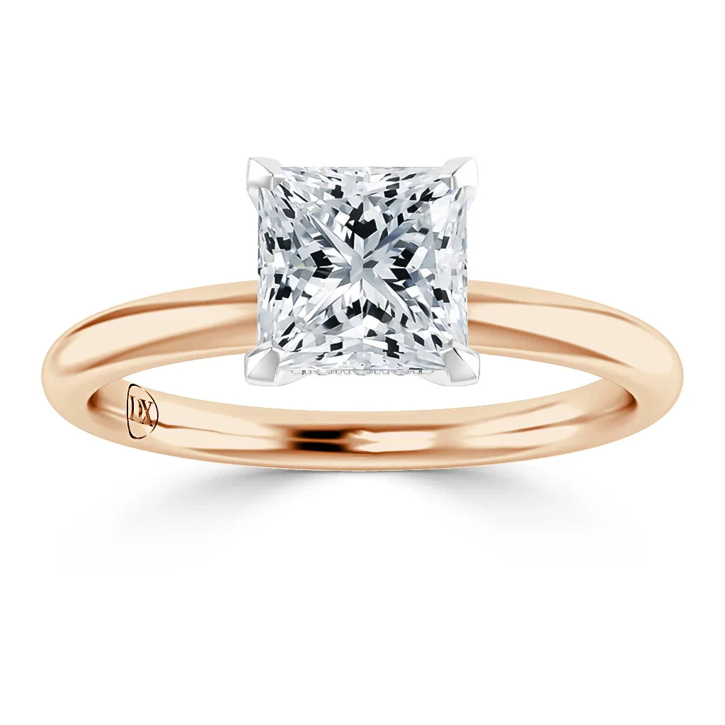A rose gold ring with a large, square-cut diamond in a four-prong solitaire setting.