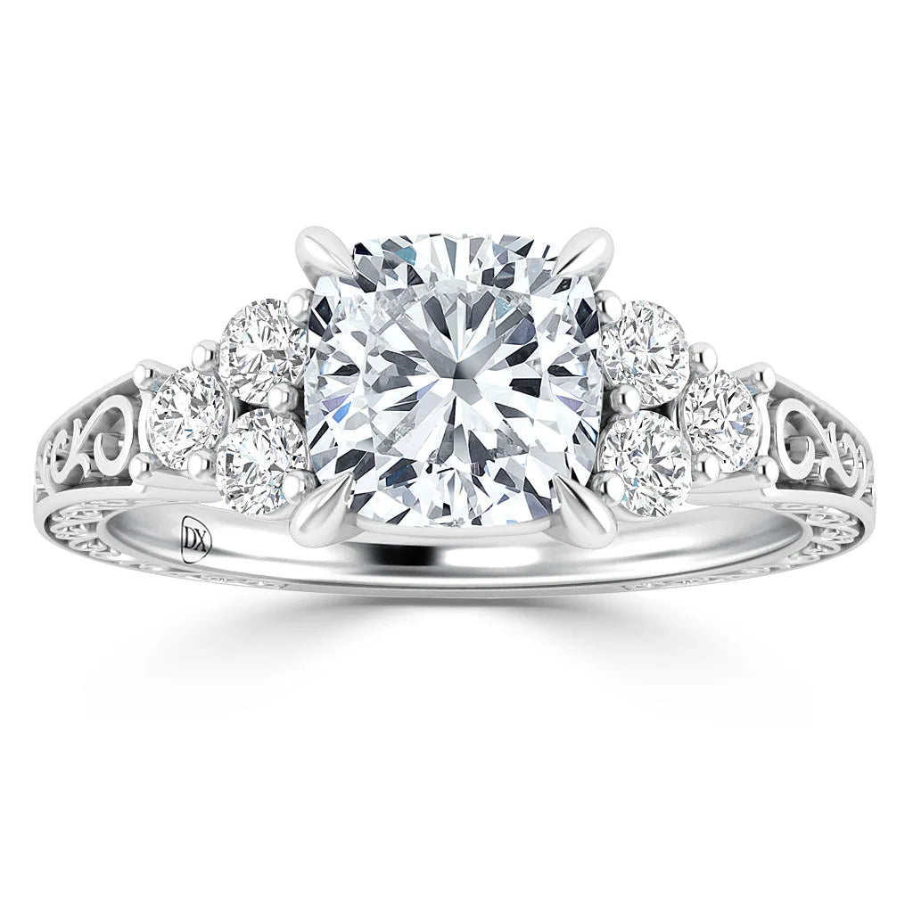 White gold ring with a large round center diamond, six side diamonds, and delicate filigree on the band.