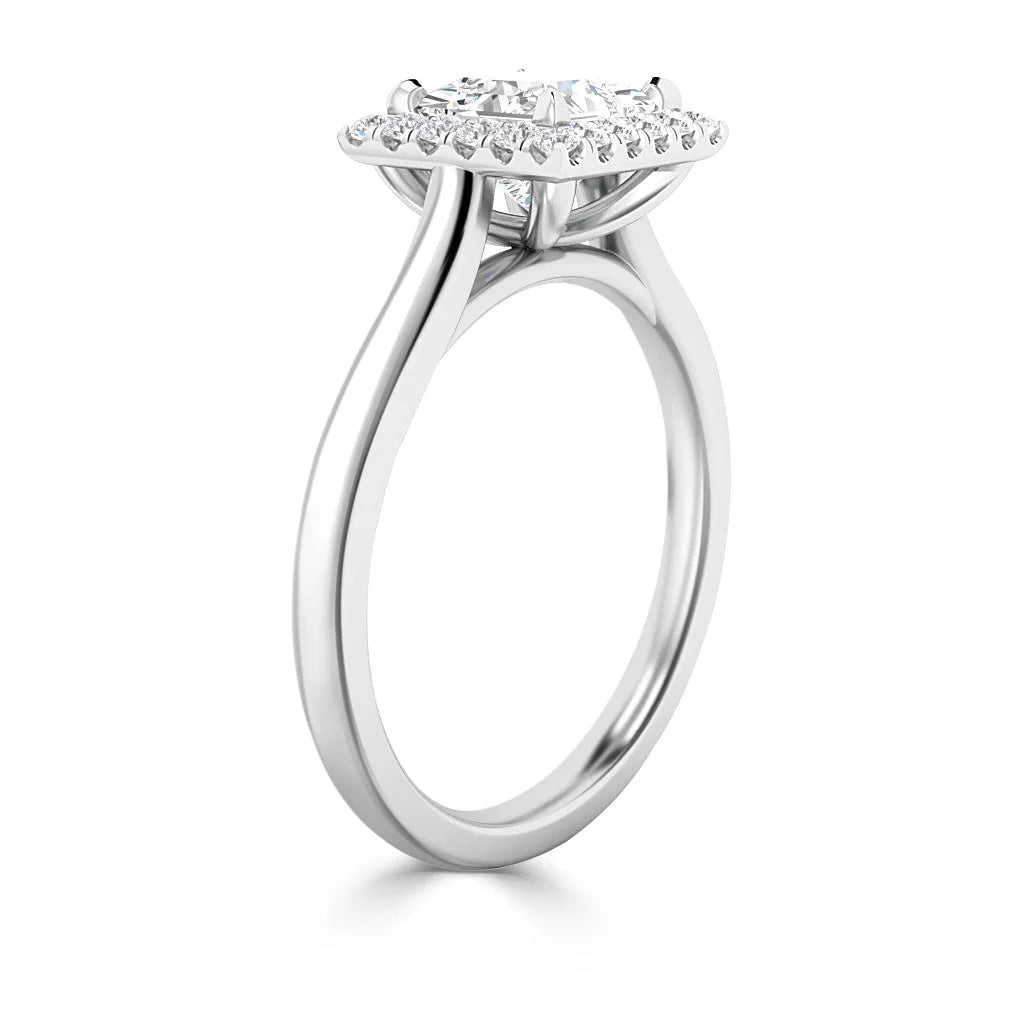 Side view of a white gold ring with a round center diamond and small diamonds in a halo setting.