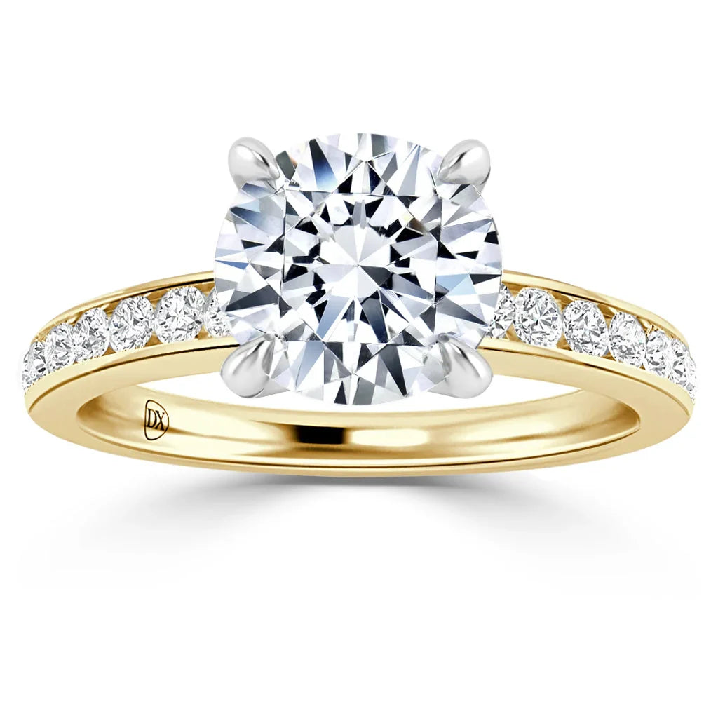 Gold ring with a large round diamond center stone and smaller diamonds set along the band, on a white background.