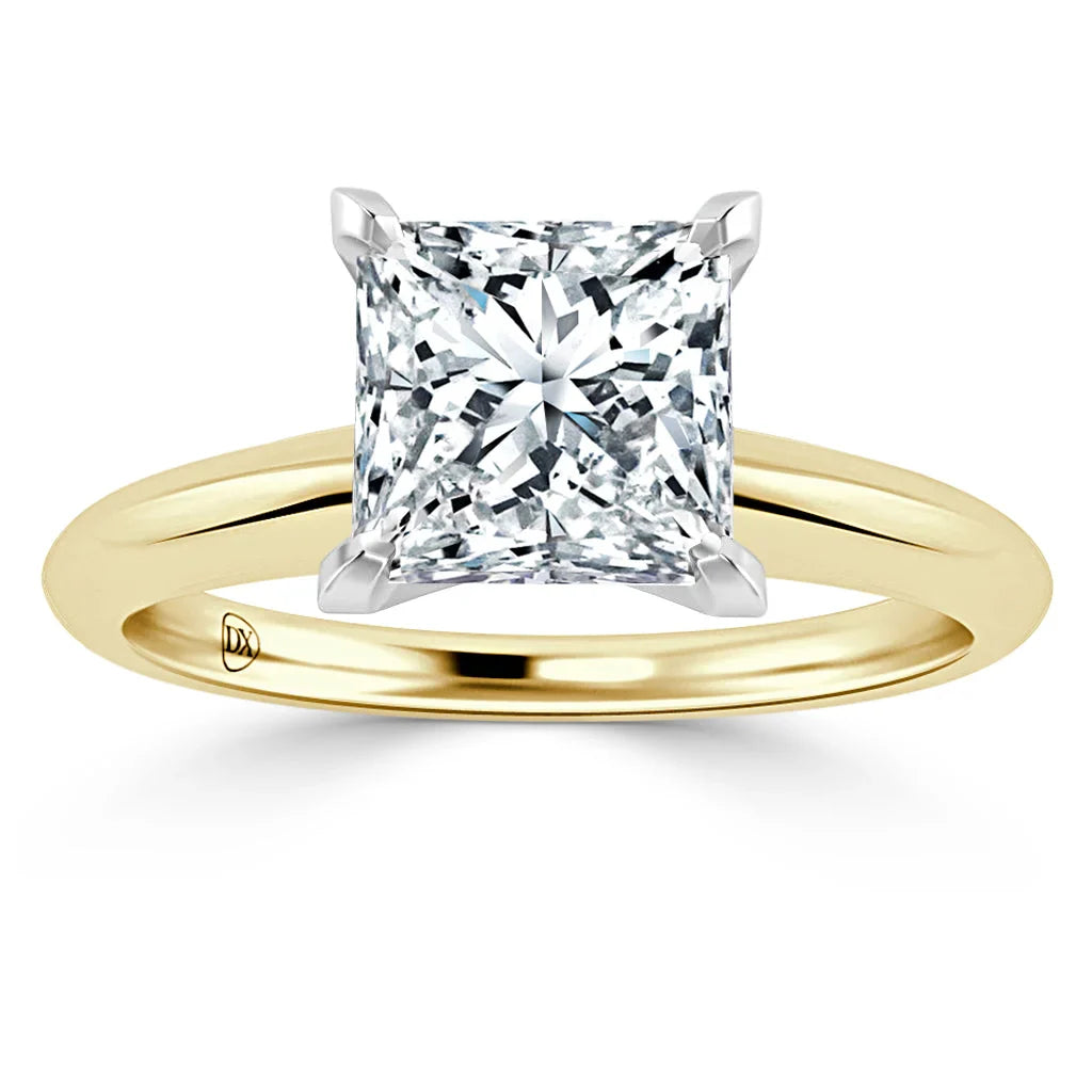 Princess-cut diamond solitaire ring with yellow gold band and white gold prongs, shown on a white background.
