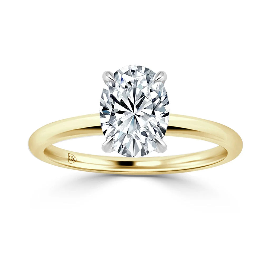 Gold band solitaire ring with an oval-cut diamond in a four-prong setting, on a white background.