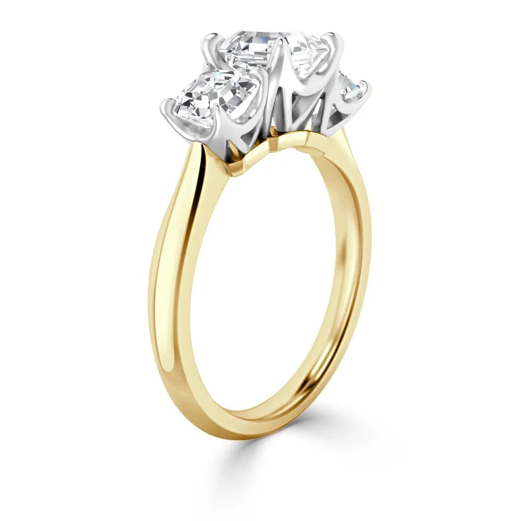 A gold ring with three round diamonds in a white prong setting, displayed on a white background.
