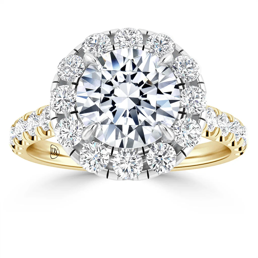 Gold ring with large central diamond, halo of smaller diamonds, and diamond accents along the band.