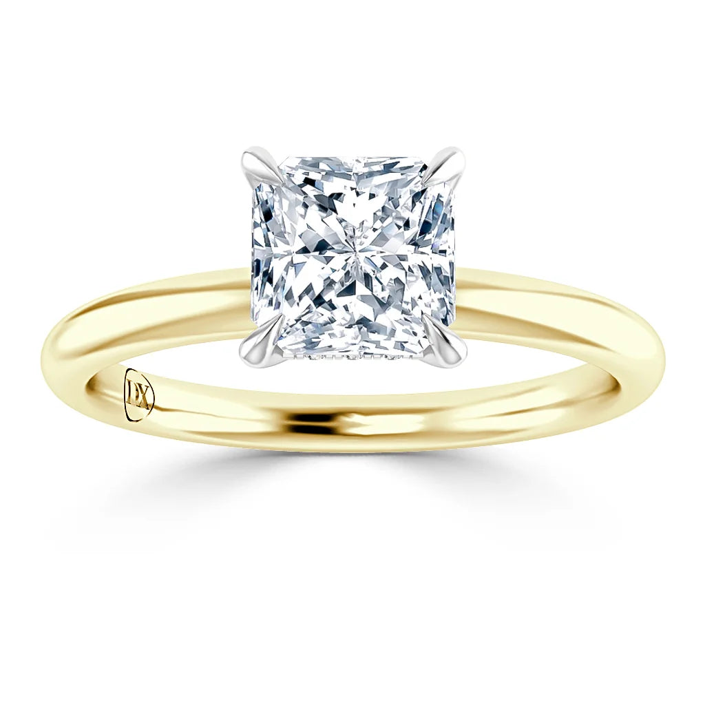 A gold ring with a square-cut diamond solitaire in a four-prong setting, viewed from the front.