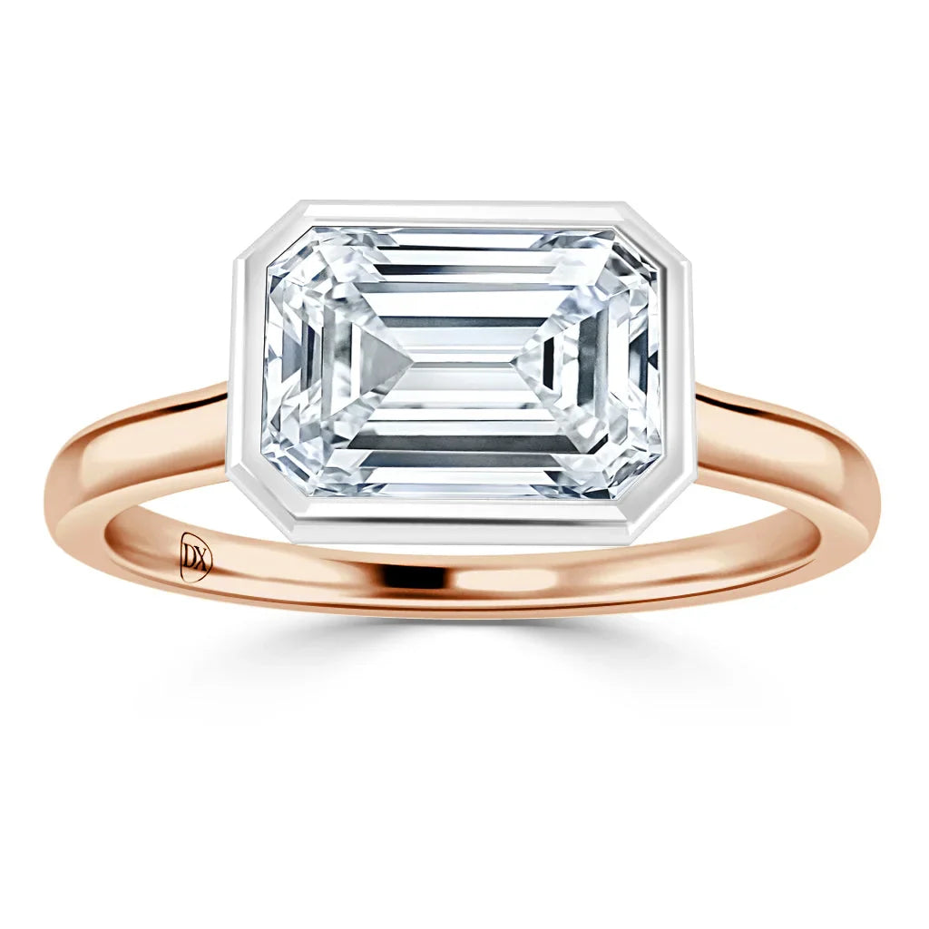 Rose gold ring with a large emerald-cut diamond in a bezel setting, viewed from the front on a white background.