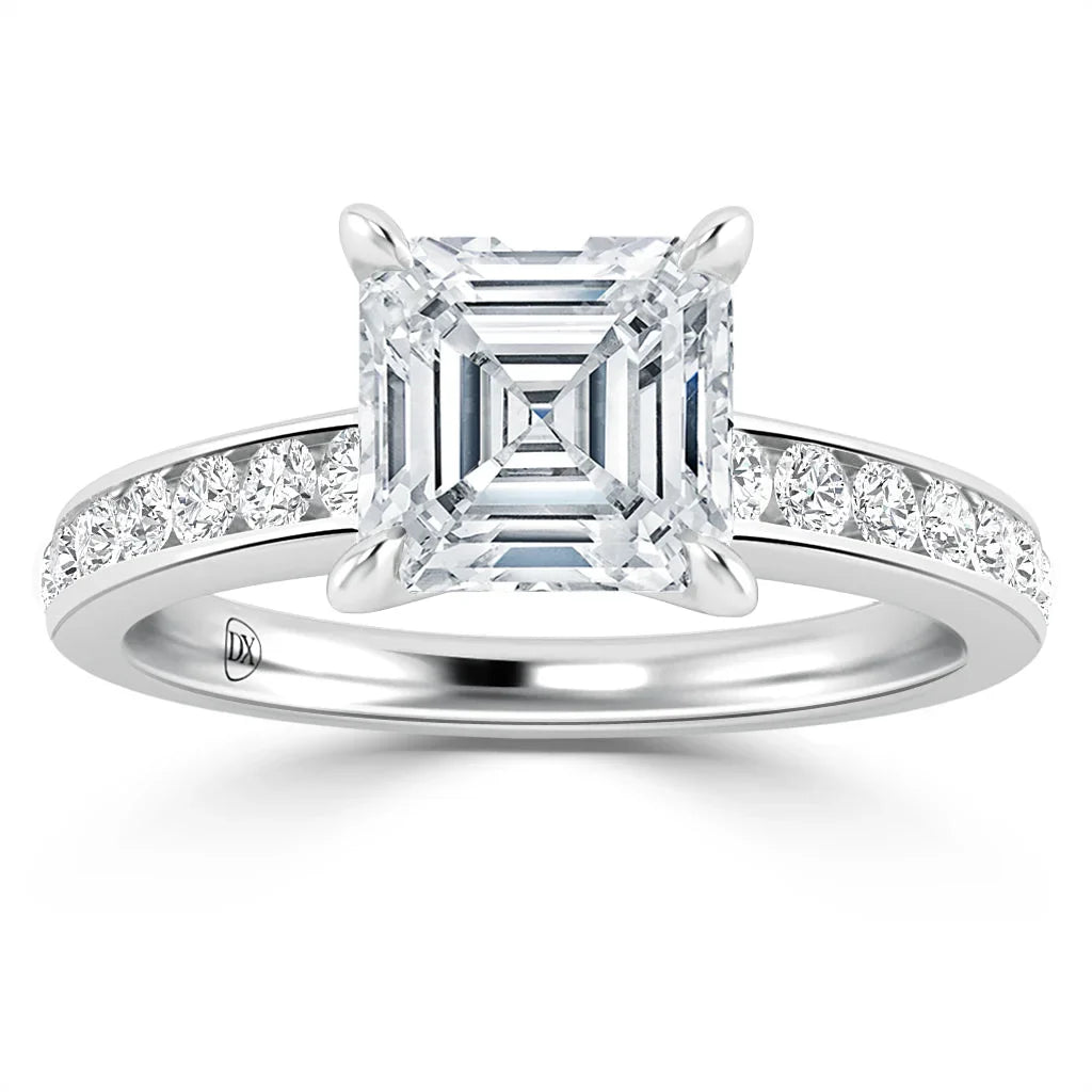 A platinum ring with an asscher-cut diamond center and smaller diamonds set along the band.