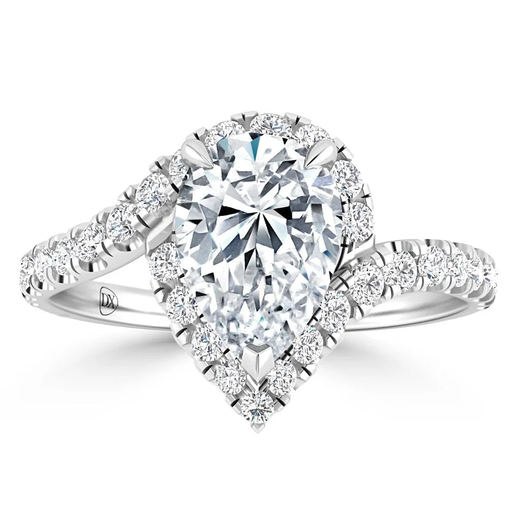 A pear-shaped diamond ring with a halo setting and a diamond-encrusted split shank band.