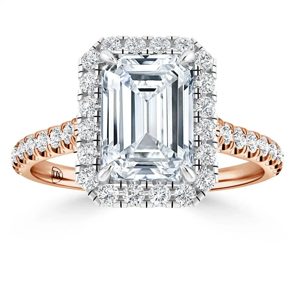 Emerald-cut diamond ring with a halo of round diamonds and a rose gold band with pavé diamonds.
