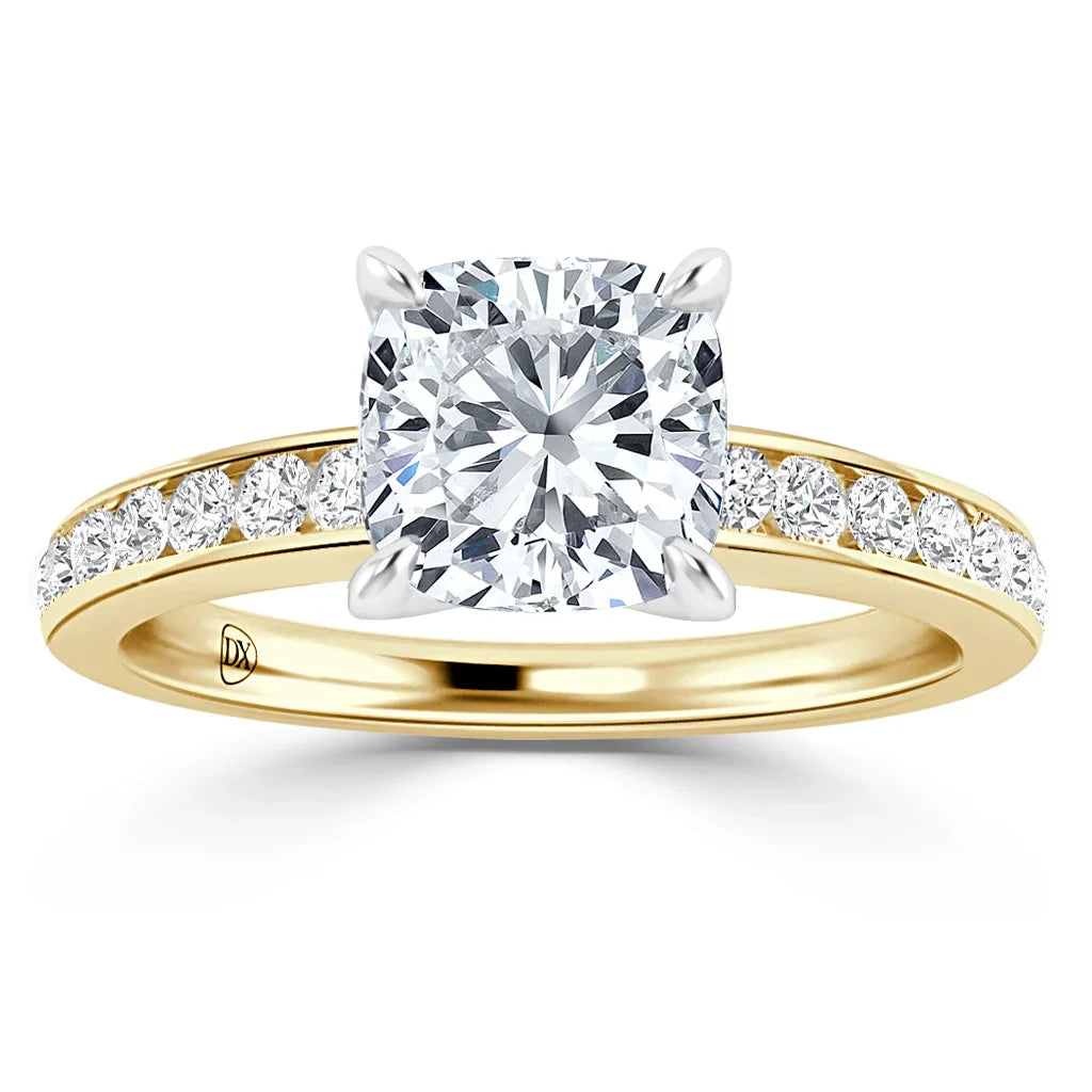Gold ring with a large cushion-cut diamond center and small diamonds along the band, viewed from the front.