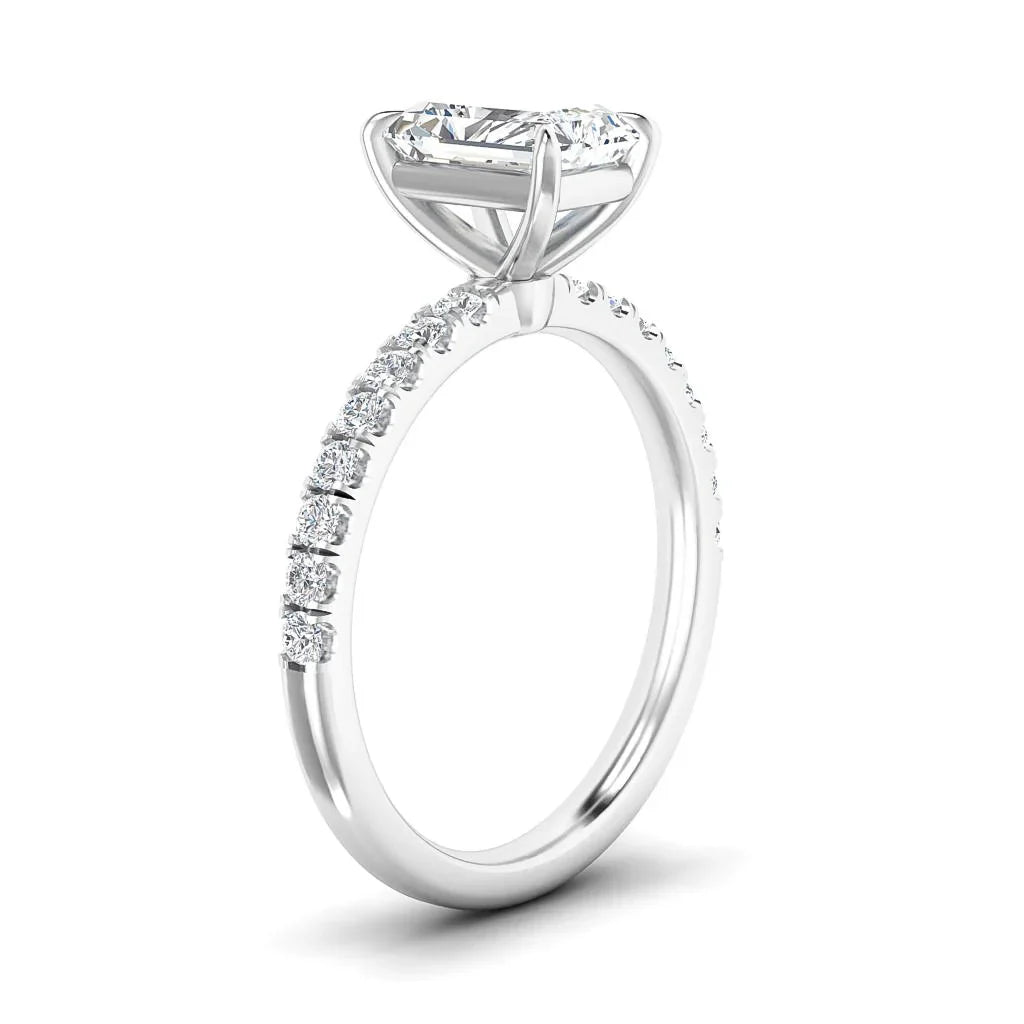 A white gold ring with round side diamonds and a large center solitaire diamond in a prong setting.