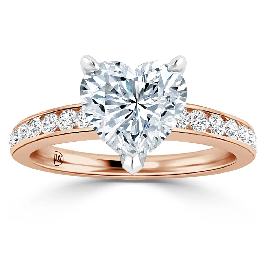 A rose gold ring with a heart-shaped diamond center and smaller diamonds along the band.