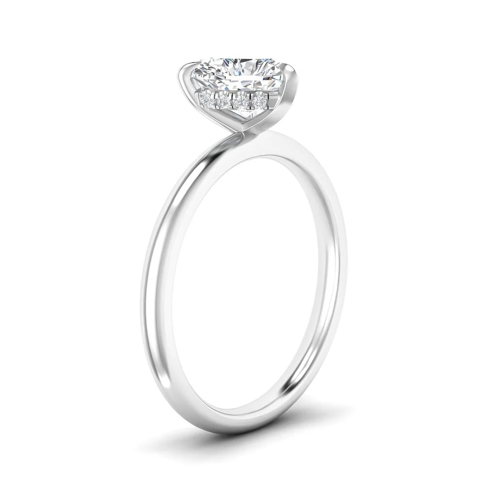 A solitaire diamond ring with a thin, plain silver band and a round diamond held by a modern prong setting.