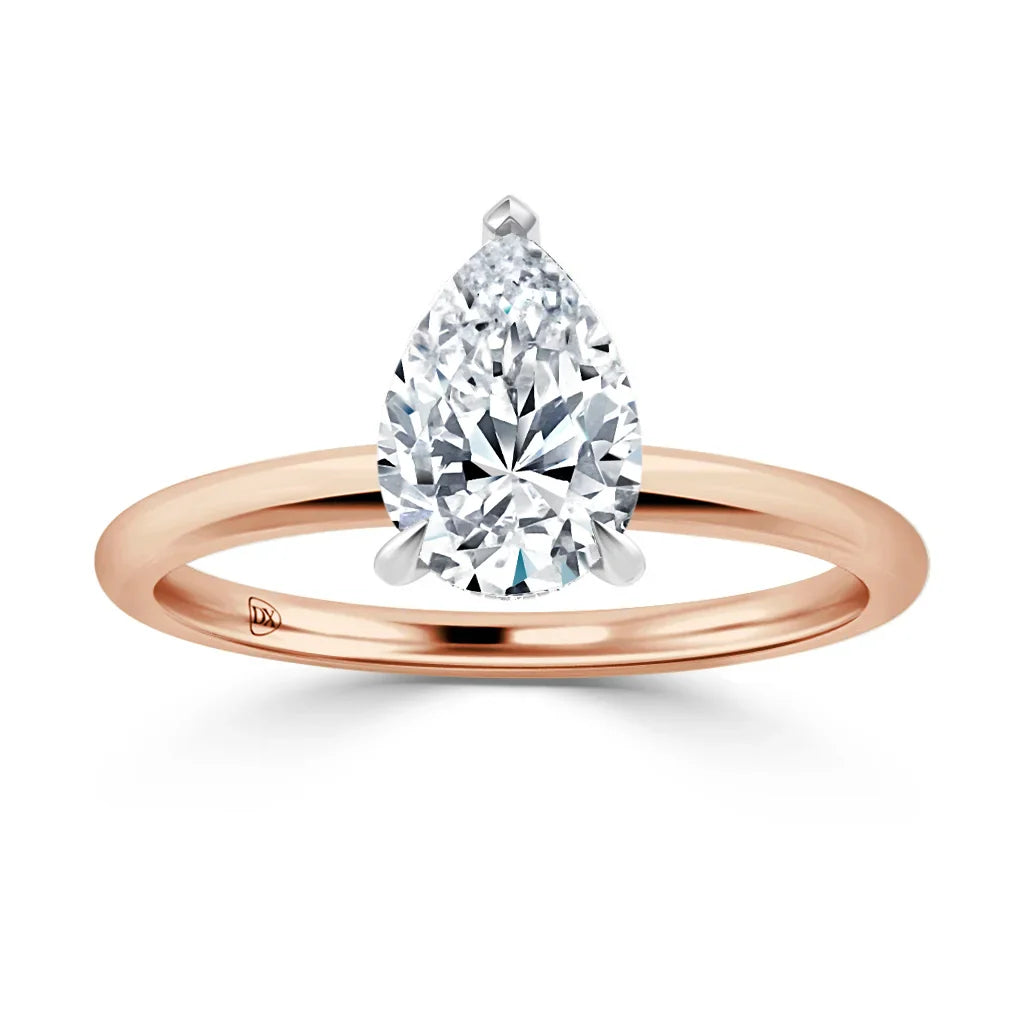 A rose gold ring with a pear-shaped diamond solitaire on a thin band, shown against a white background.