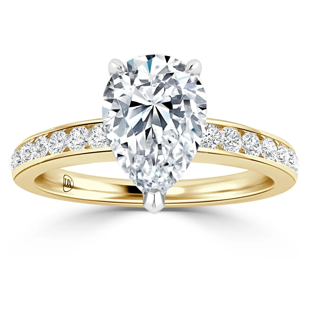 Gold ring with a large pear-shaped diamond and smaller diamonds set along the band.