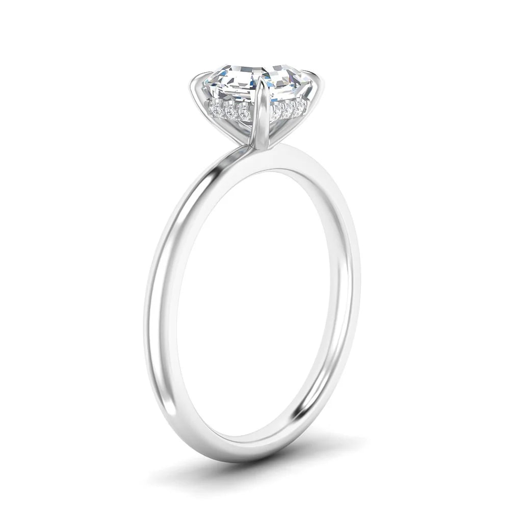 Platinum solitaire engagement ring with a round diamond in a prong setting, viewed from the side.