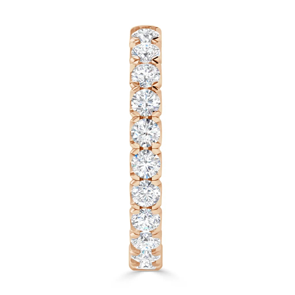 A thin gold ring set with nine round, sparkling white diamonds in a vertical row, shown from the front.