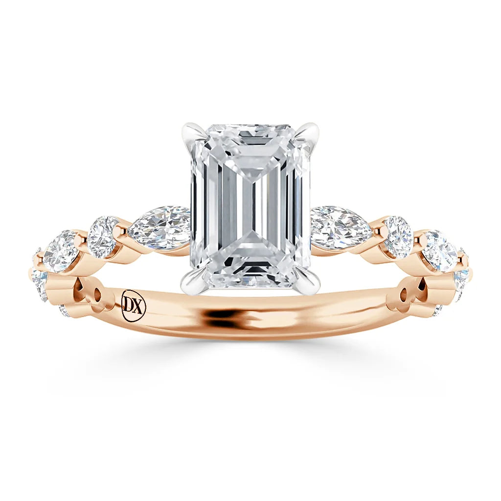Emerald-cut diamond ring with marquise side stones on a rose gold band, viewed from the front.