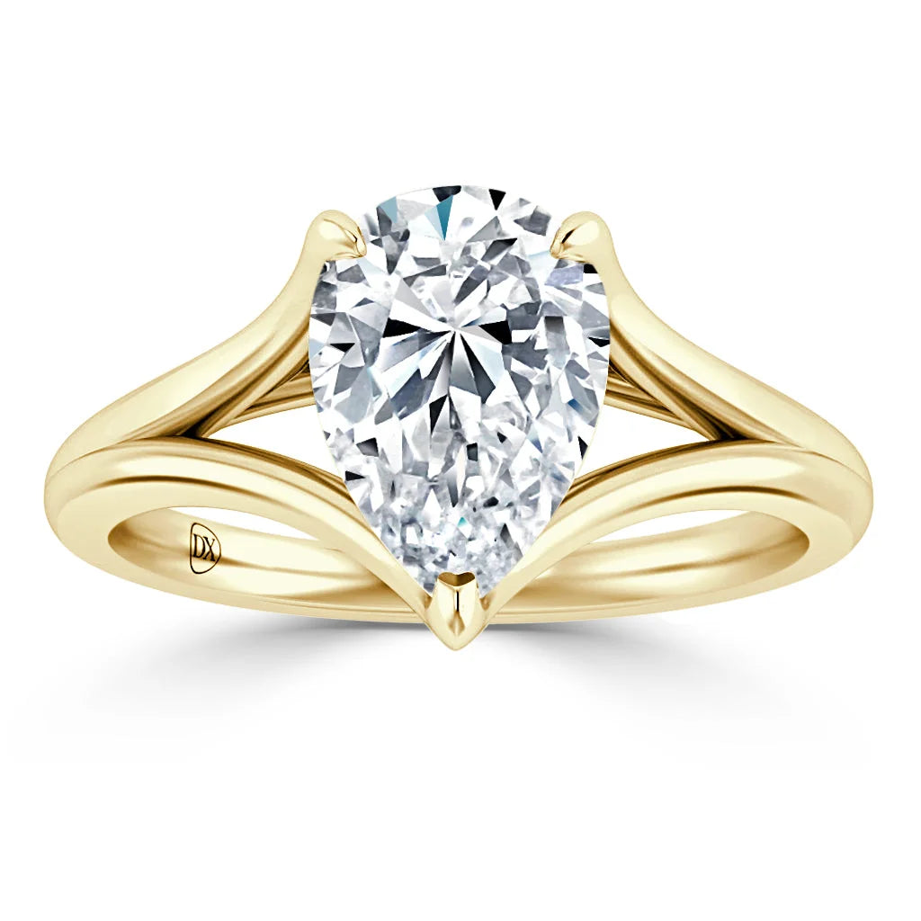 A pear-shaped diamond ring with a split yellow gold band and pointed prongs on a white background.