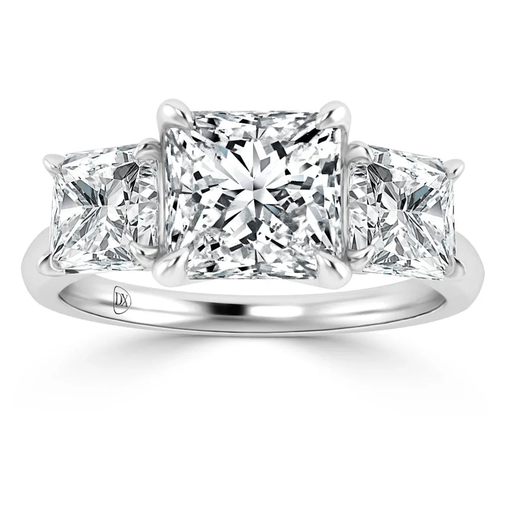 Three-stone ring with princess-cut diamonds set in a polished white gold band, viewed from the front.