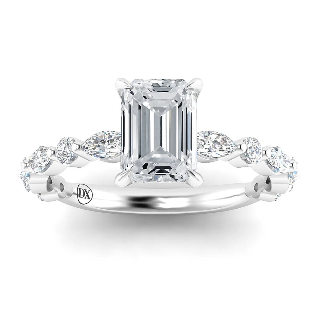 Emerald-cut diamond ring with a twisted band set with marquise and round diamonds on white gold.