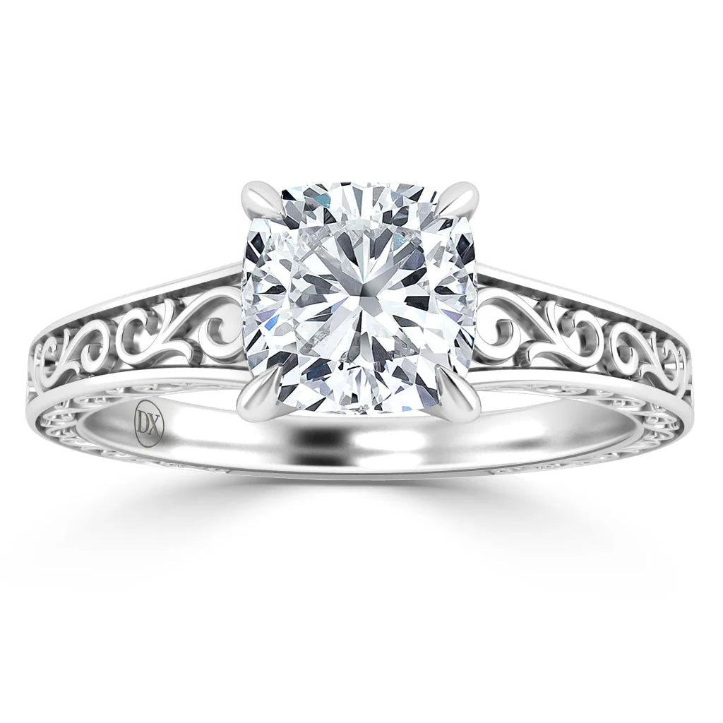 Silver ring with a large cushion-cut diamond and intricate filigree design on the band.