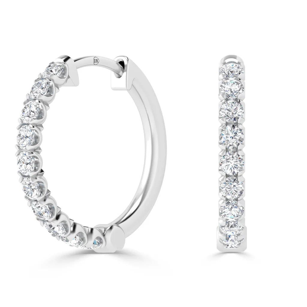 Two white gold hoop earrings, each set with a row of sparkling round-cut diamonds on the front.