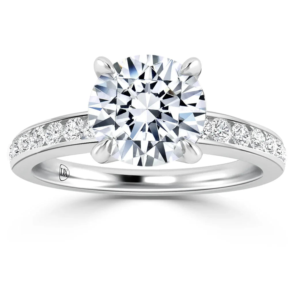 A white gold ring with a large round diamond center and smaller diamonds set along the band.