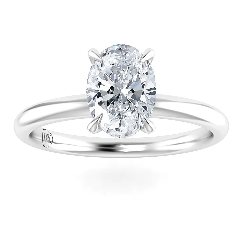 A silver ring with a single oval-cut diamond in a four-prong setting on a plain band.
