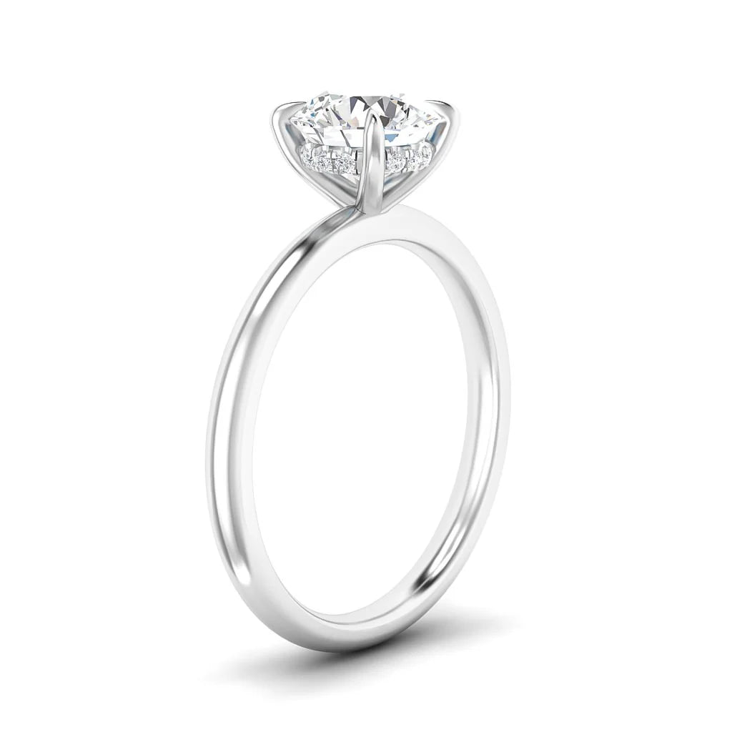 Slim platinum ring with a round solitaire diamond in a four-prong setting, shown on a white background.