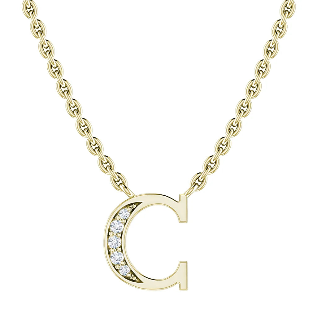 Gold chain necklace with a “C” pendant, half adorned with small round white gemstones.